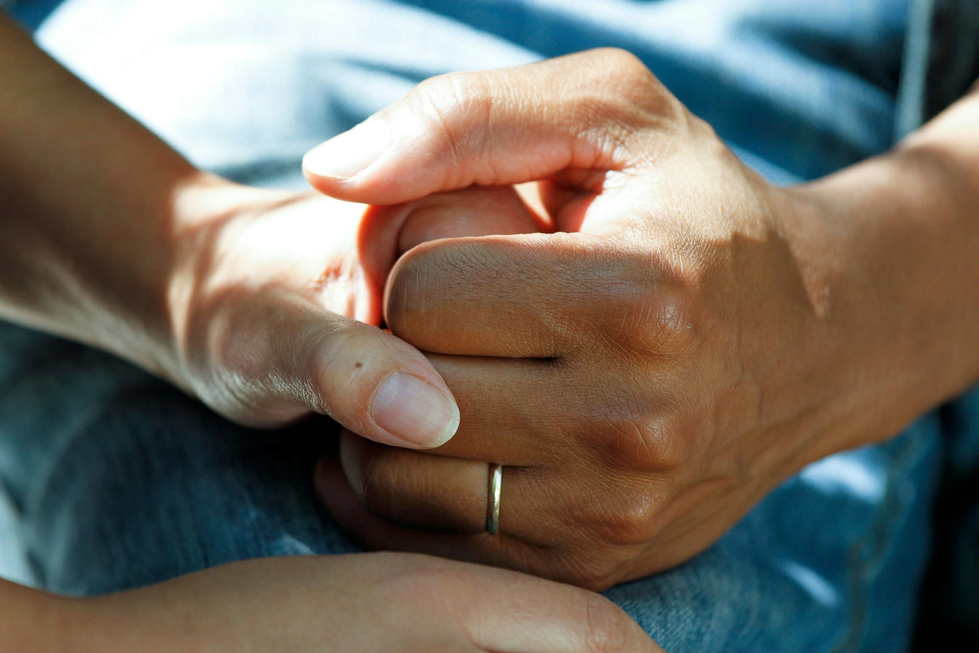 Caregiver holding hands with older lady
