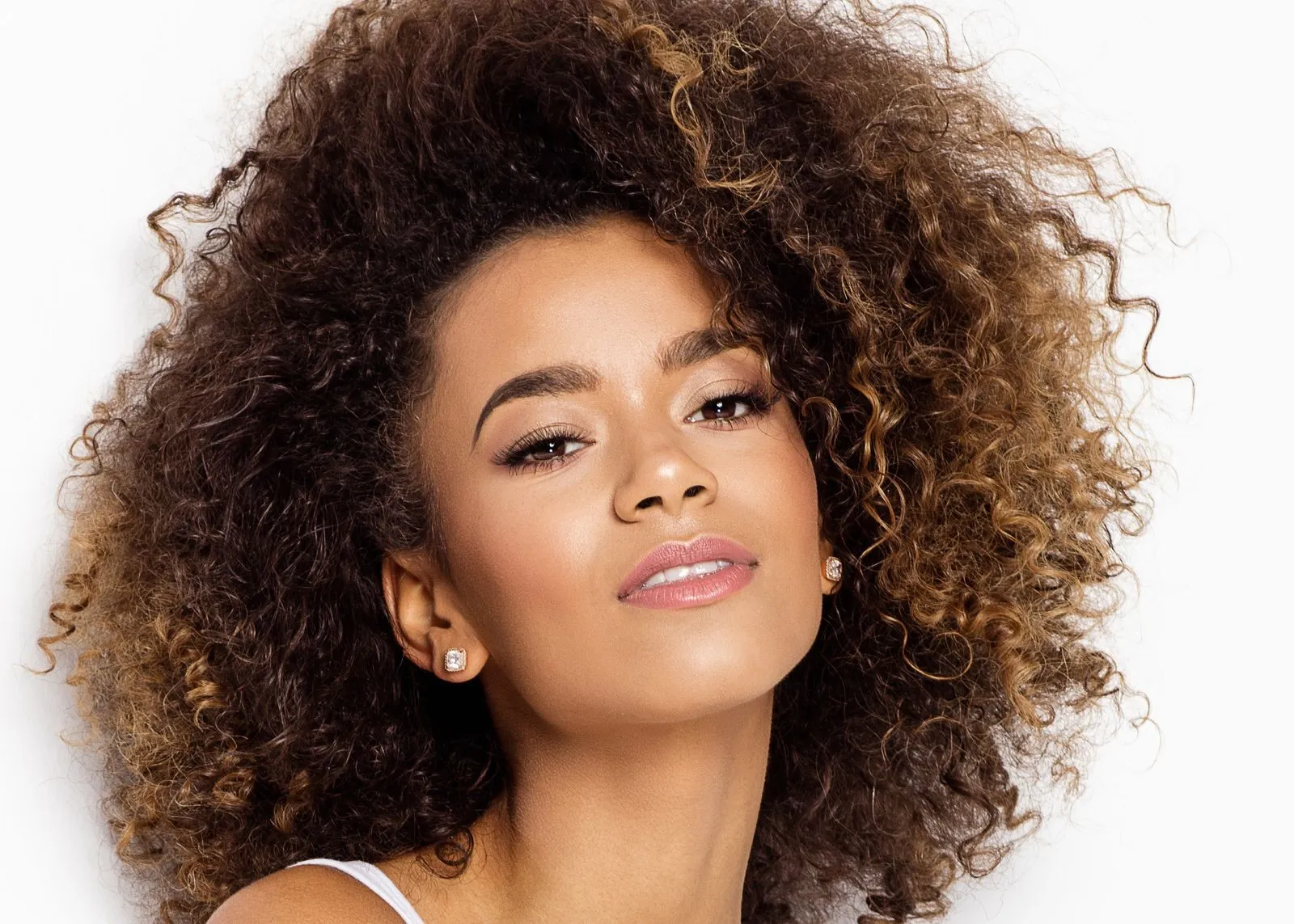 A close up of a woman with curly hair.