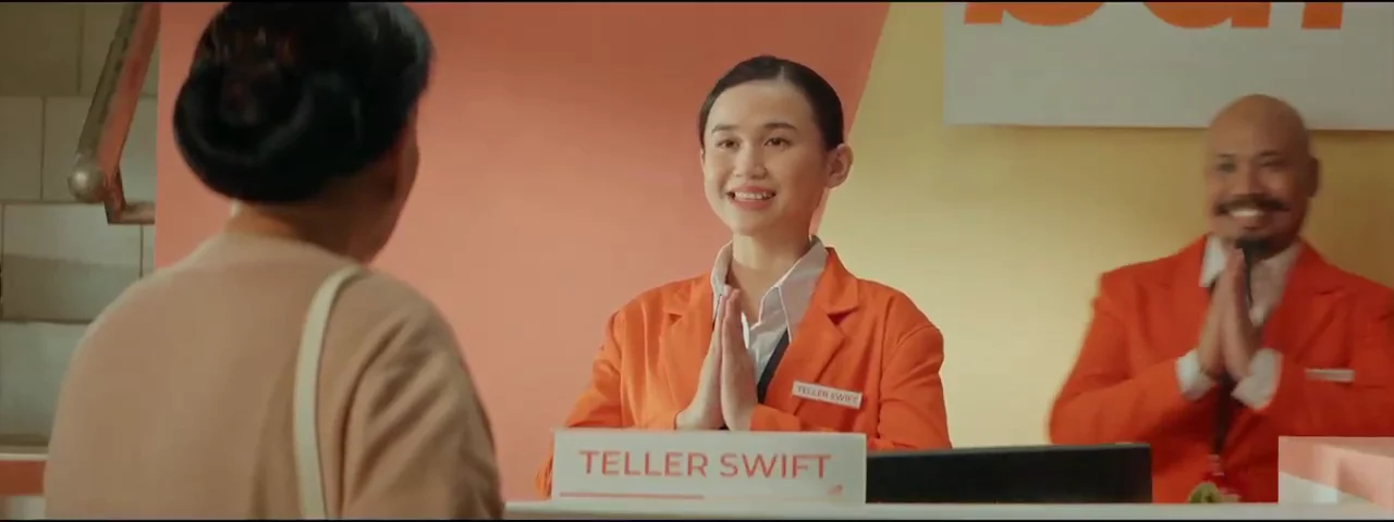 Teller Swift bank scene in the original LPS TVC
