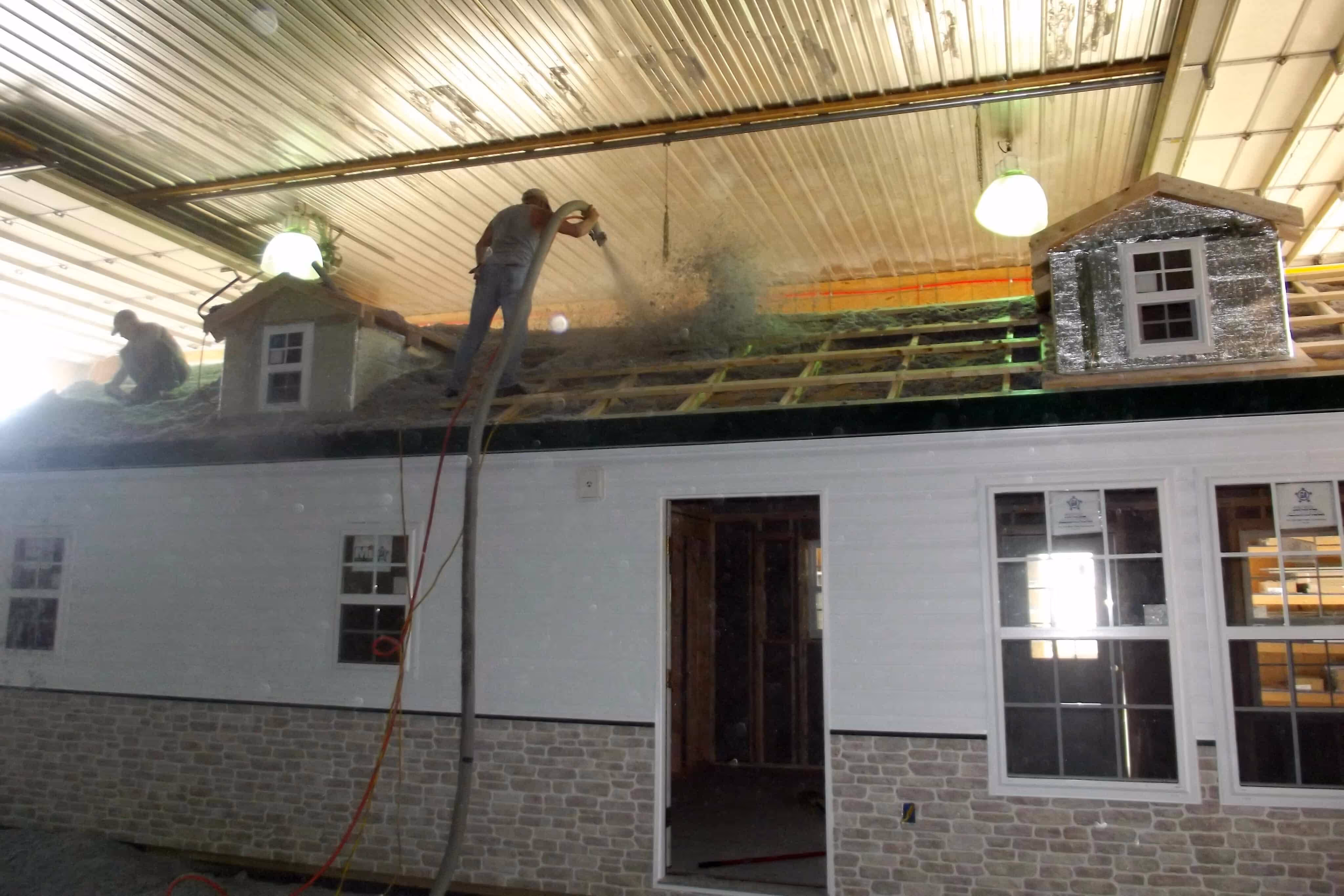 16x40 cabin spraying insulation on roof