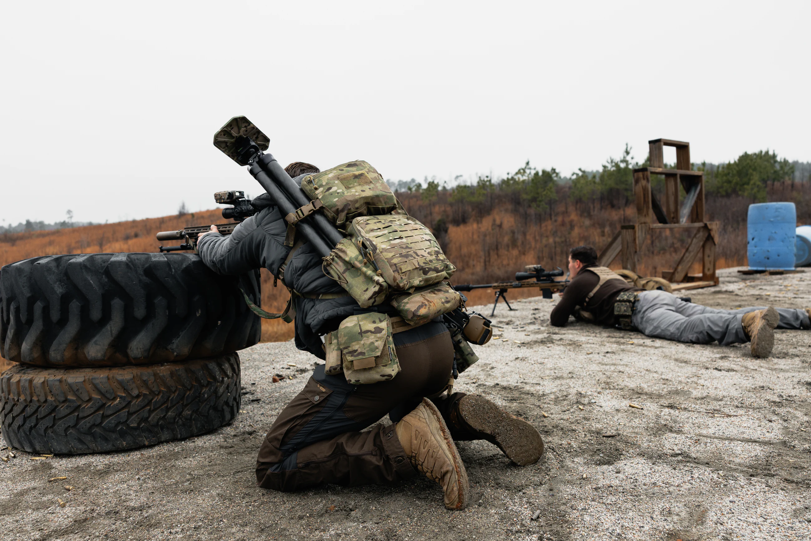 Two-person rifle team engaging separate targets during a field stage