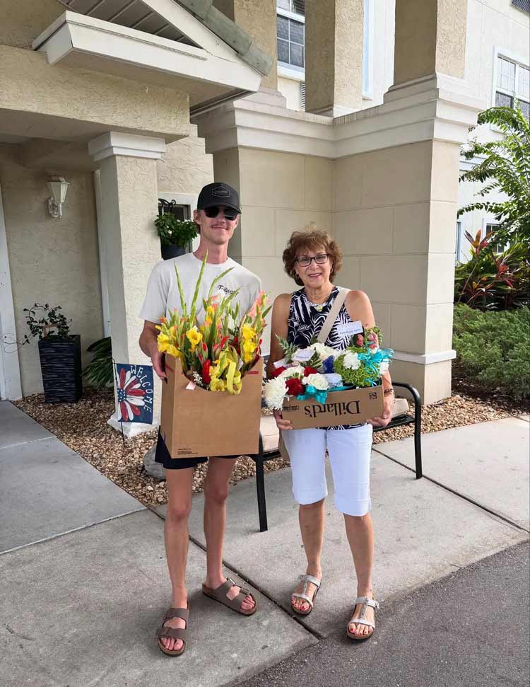Random Acts of Flowers Tampa Bay community flower delivery outside residential building