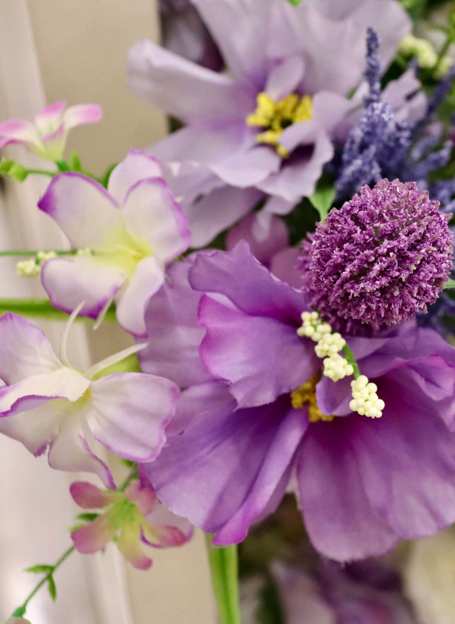 A close-up view of a floral arrangement featuring light purple and lavender flowers. 