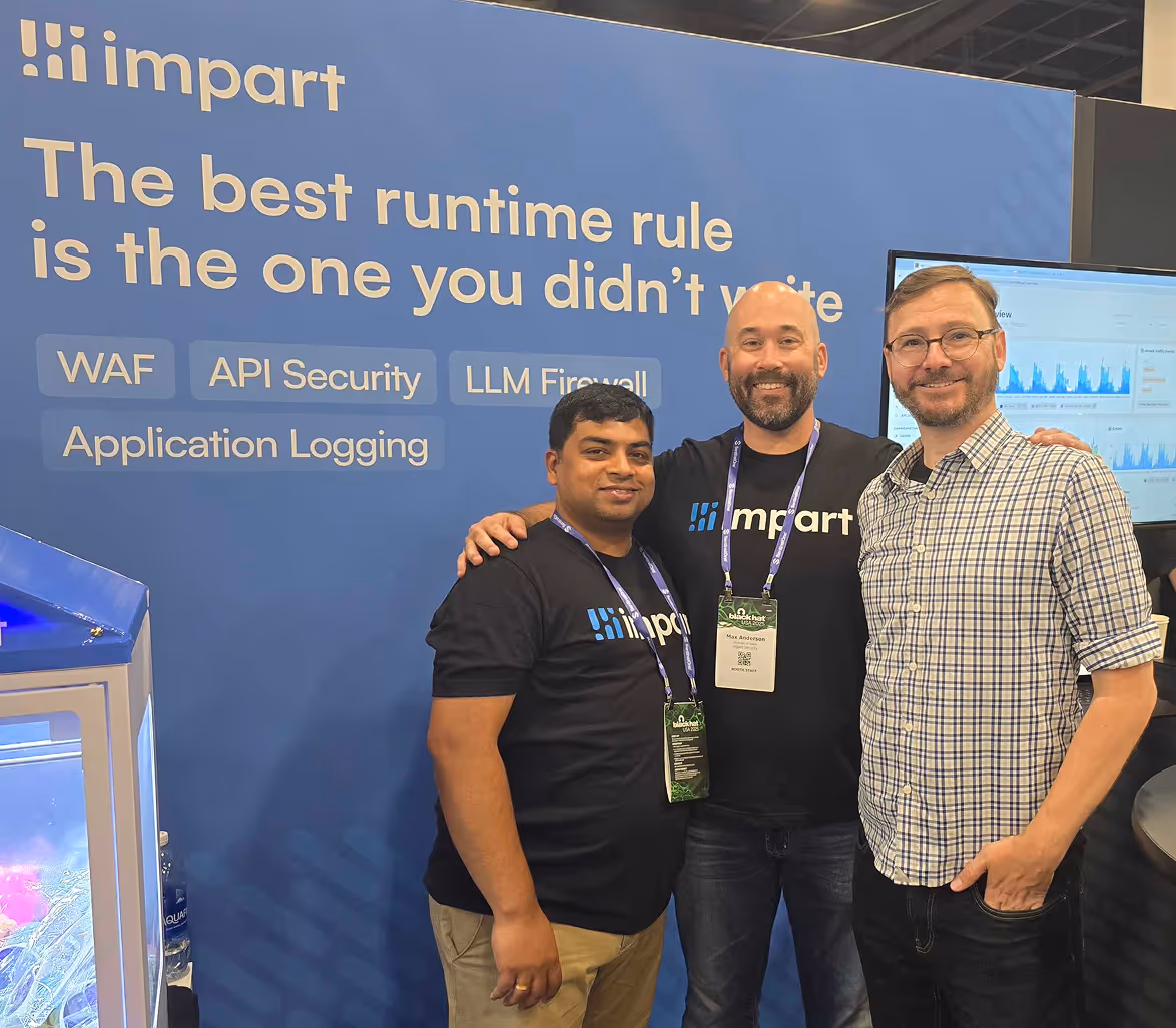 Three men standing in front of Impart sign