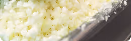 Close-up of white rice in a black rectangular container.