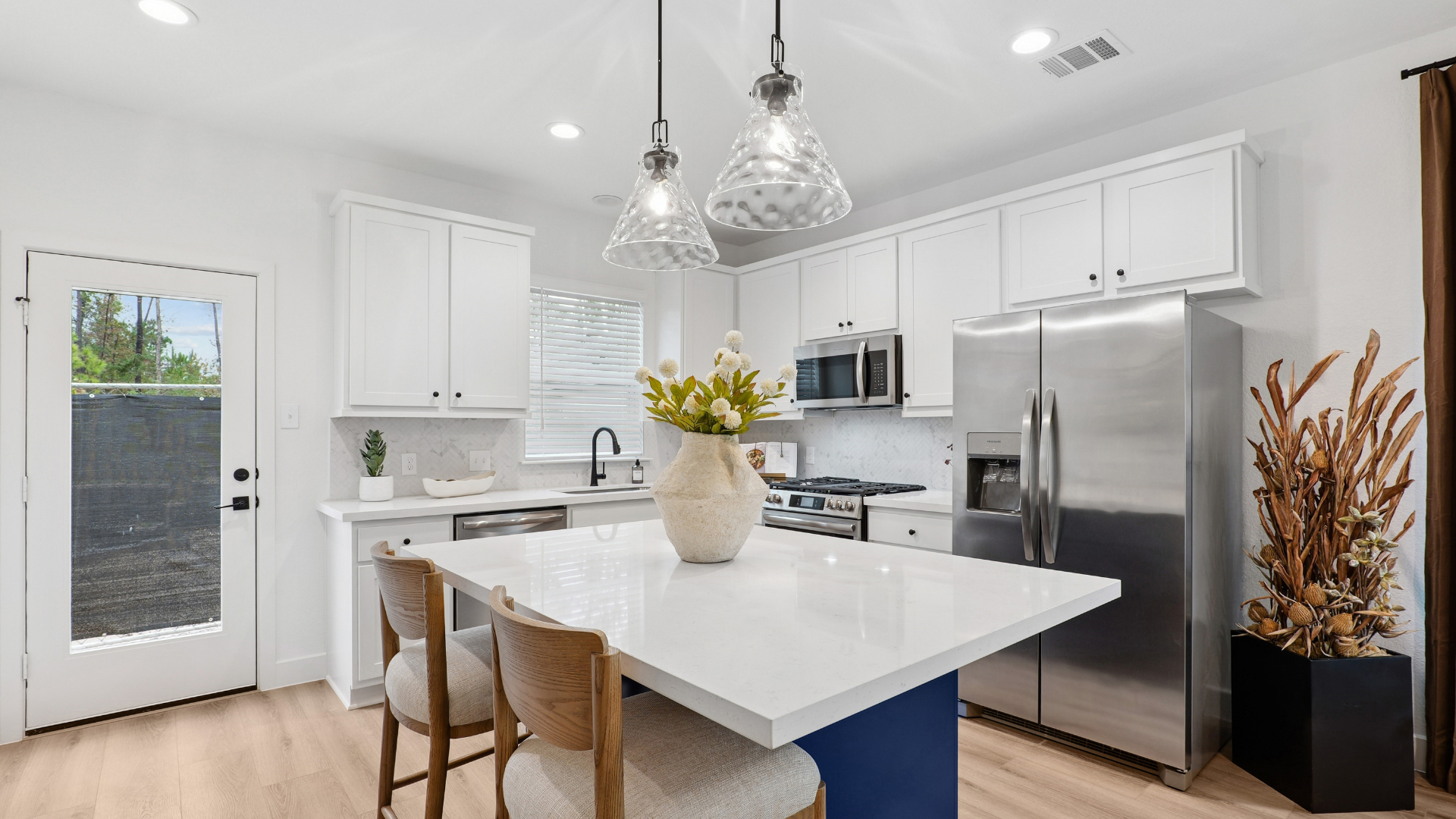 Luxurious clubhouse lounge with exposed wooden beams, a modern screen divider, and large windows overlooking the pool at a luxury community in Humble, TX.