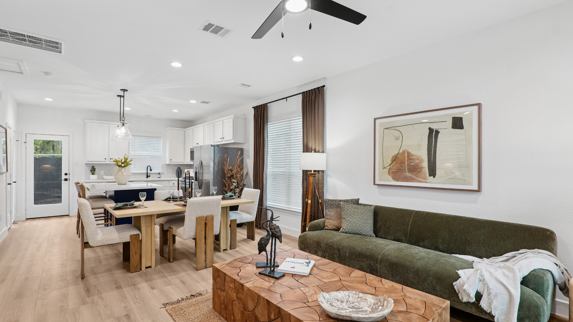 Luxurious clubhouse lounge with exposed wooden beams, a modern screen divider, and large windows overlooking the pool at a luxury community in Humble, TX.