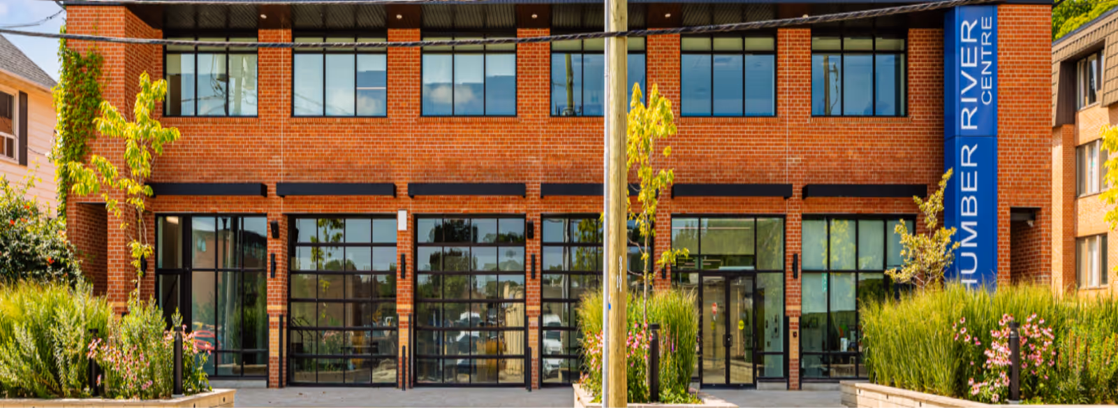 A brick building with a blue sign on the front of it.