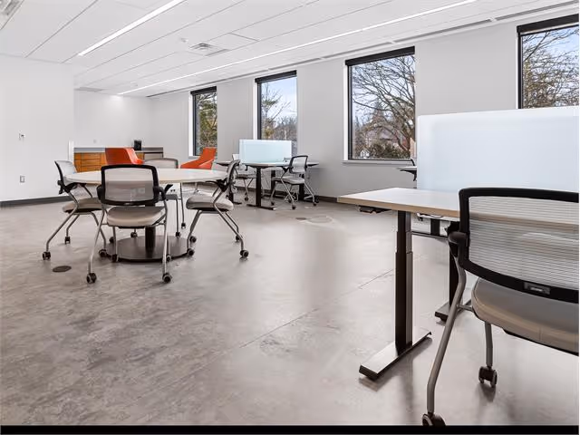 A room with a lot of chairs and desks.