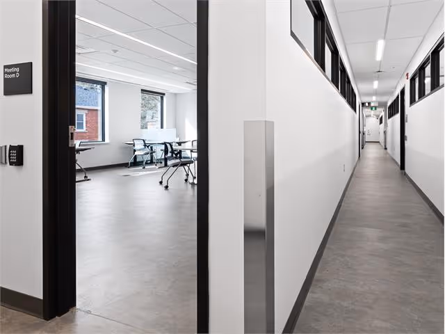 A long hallway leading to an office building.