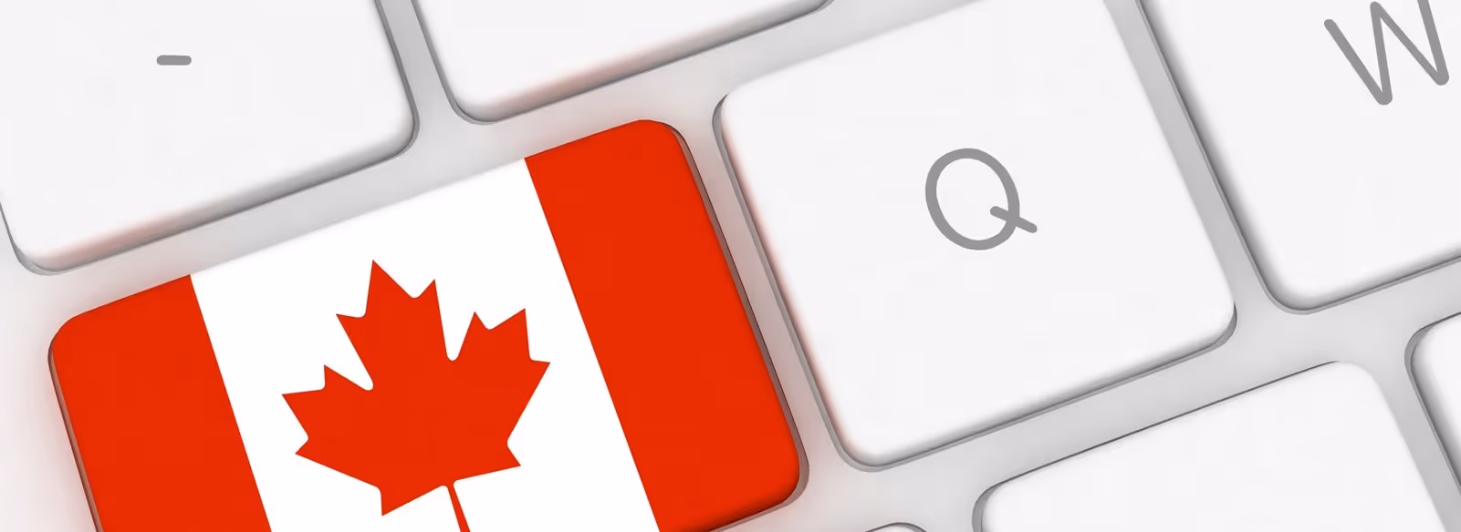 A red and white canada flag on a keyboard.
