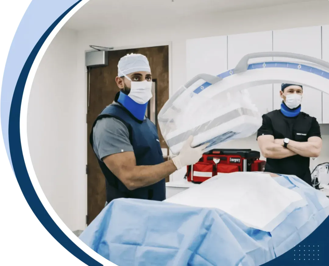 Physicians using image-guided C-arm technology during a non-surgical procedure