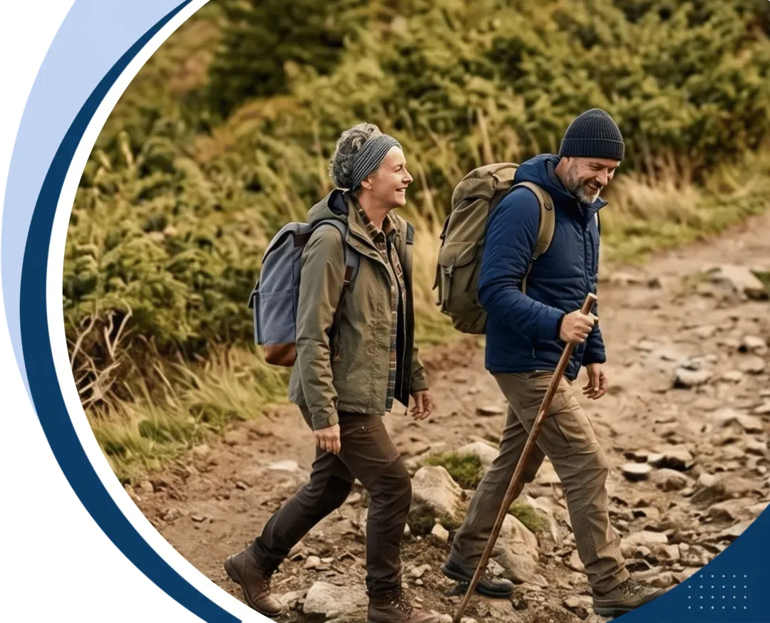Active older couple hiking a rocky mountain trail
