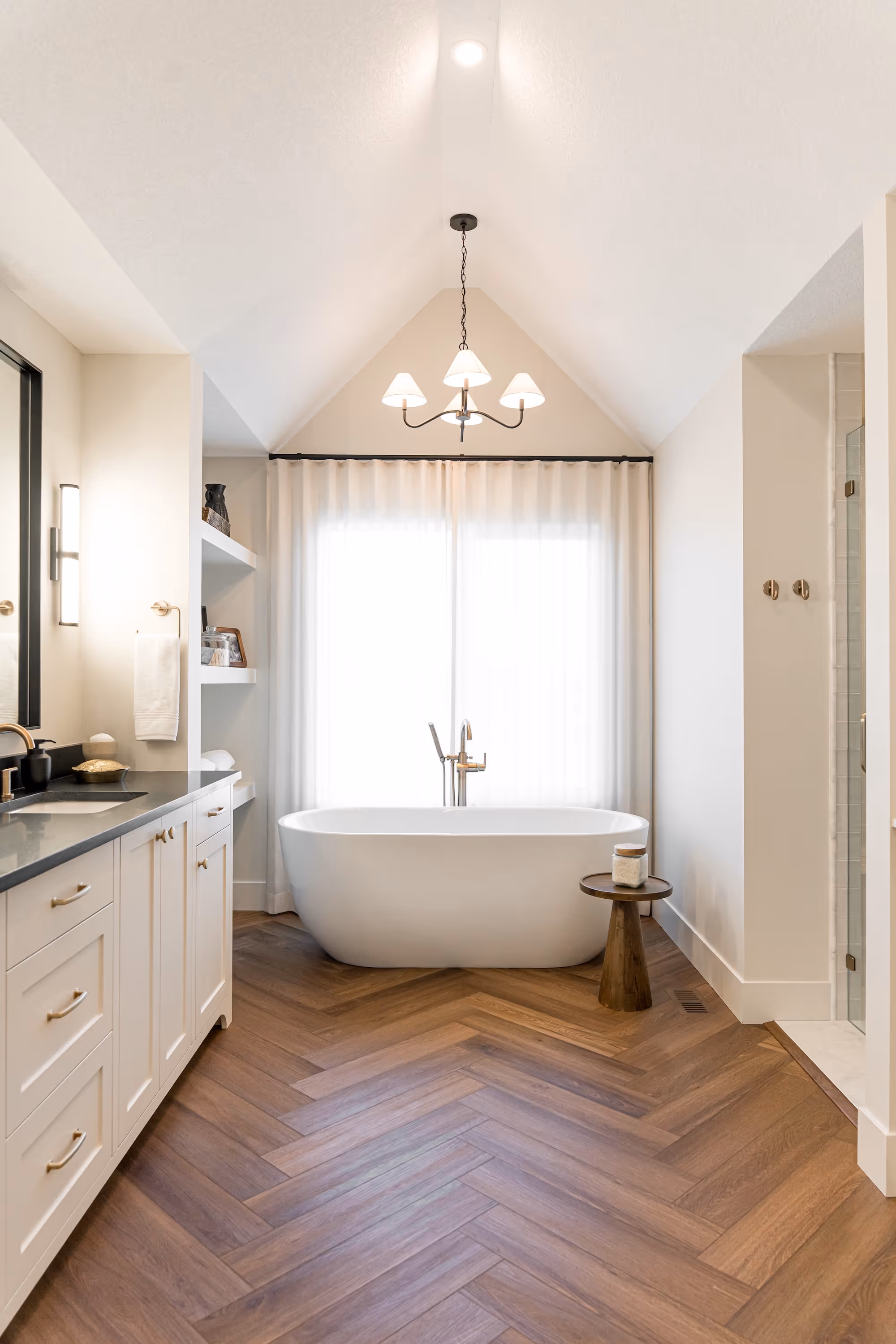 A bathroom with a tub, sink, and shower in it.