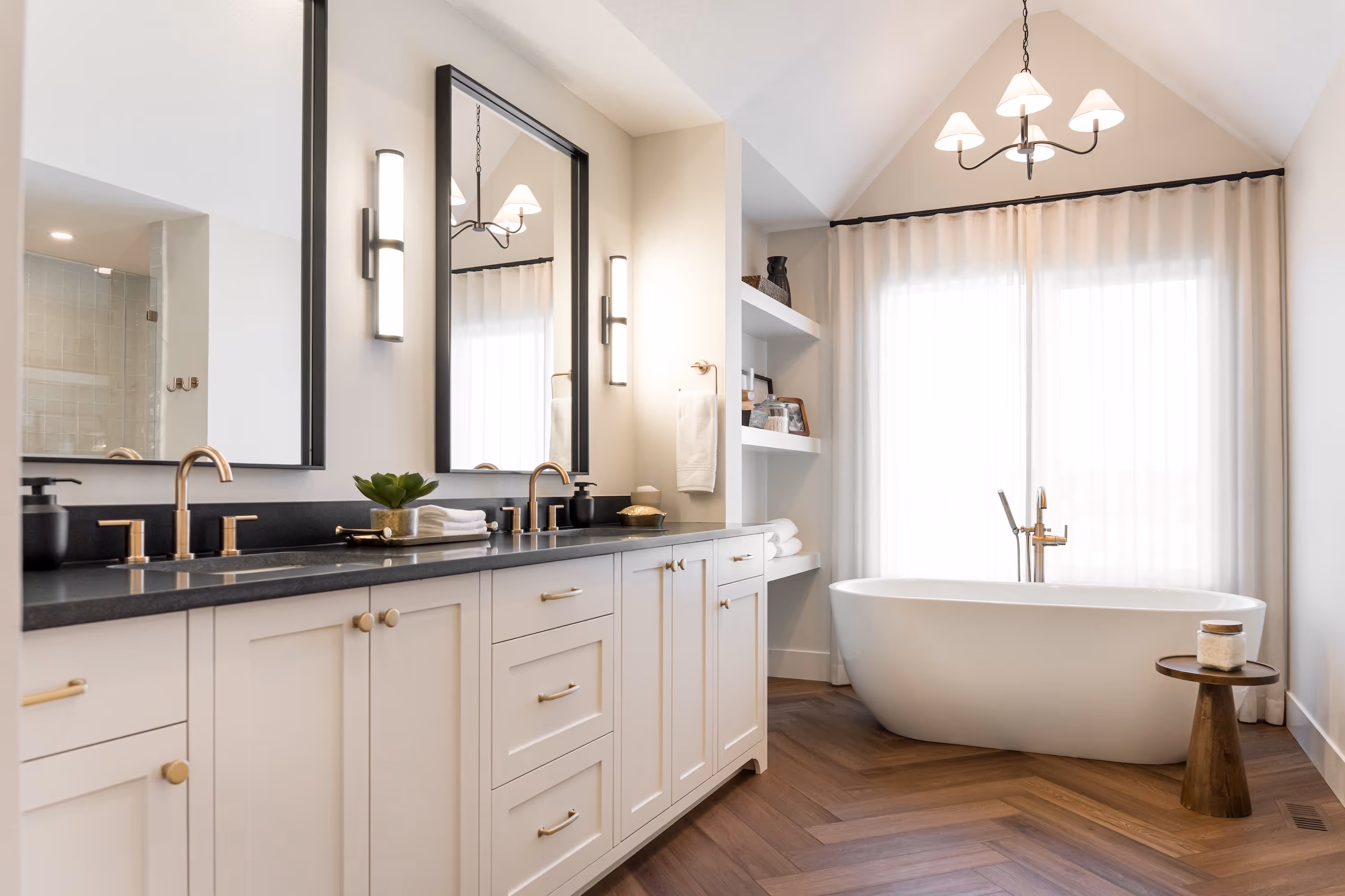 A bathroom with a tub, sink, and mirror.
