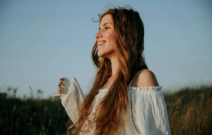 Woman smiling outdoors in a country side