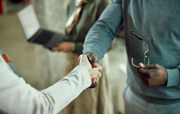 Hands shaking between two professionals