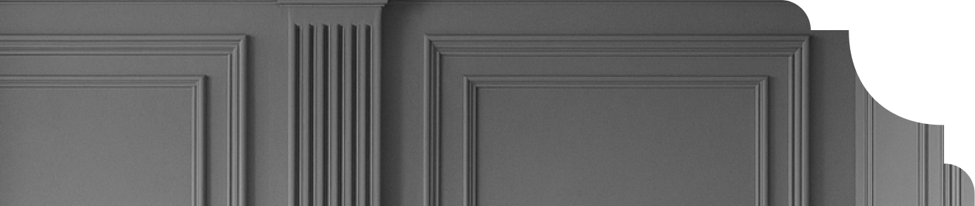 Grey wall paneling featuring decorative moulding and vertical grooves, highlighting modern interior design elements.