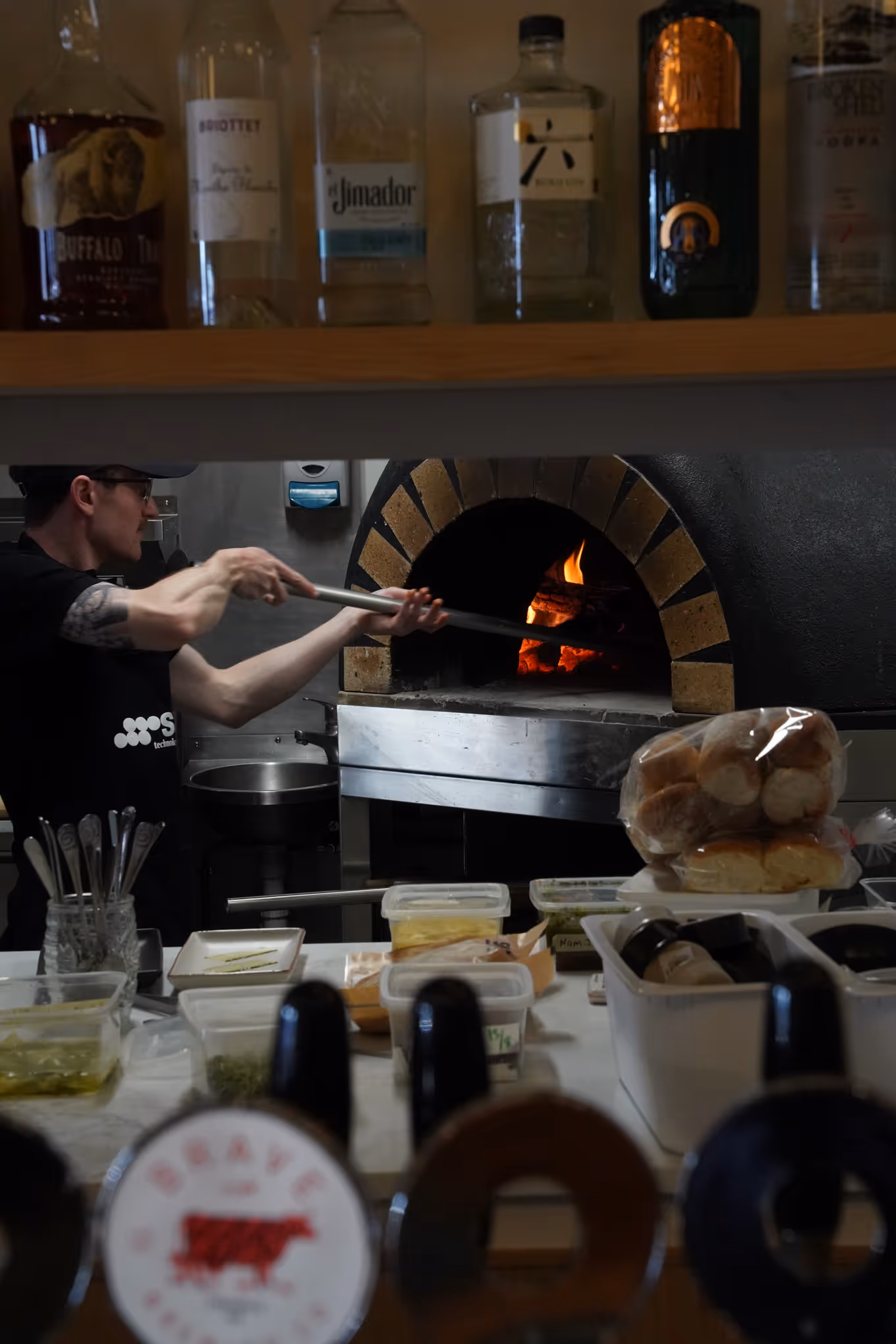 $30,000 Wood-Fired Pizza Oven - Staff taking pizza out