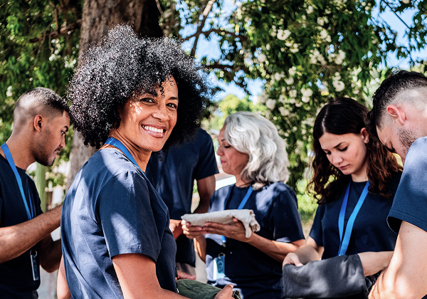 A group of community volunteers smiling together.