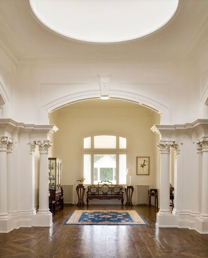 A Victorian style sitting room featuring a table and two chairs