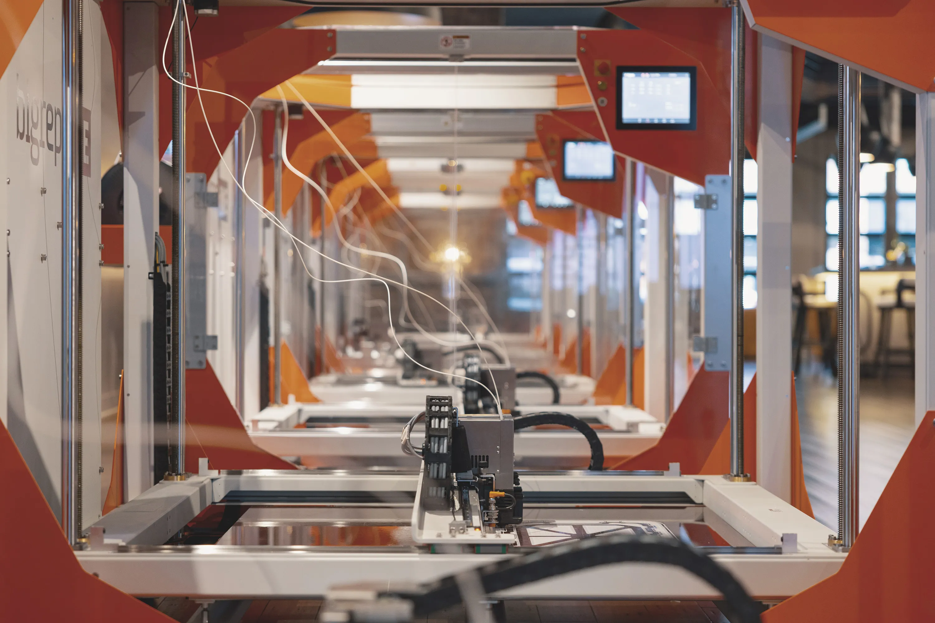 Rows of industrial 3D printers in a print farm
