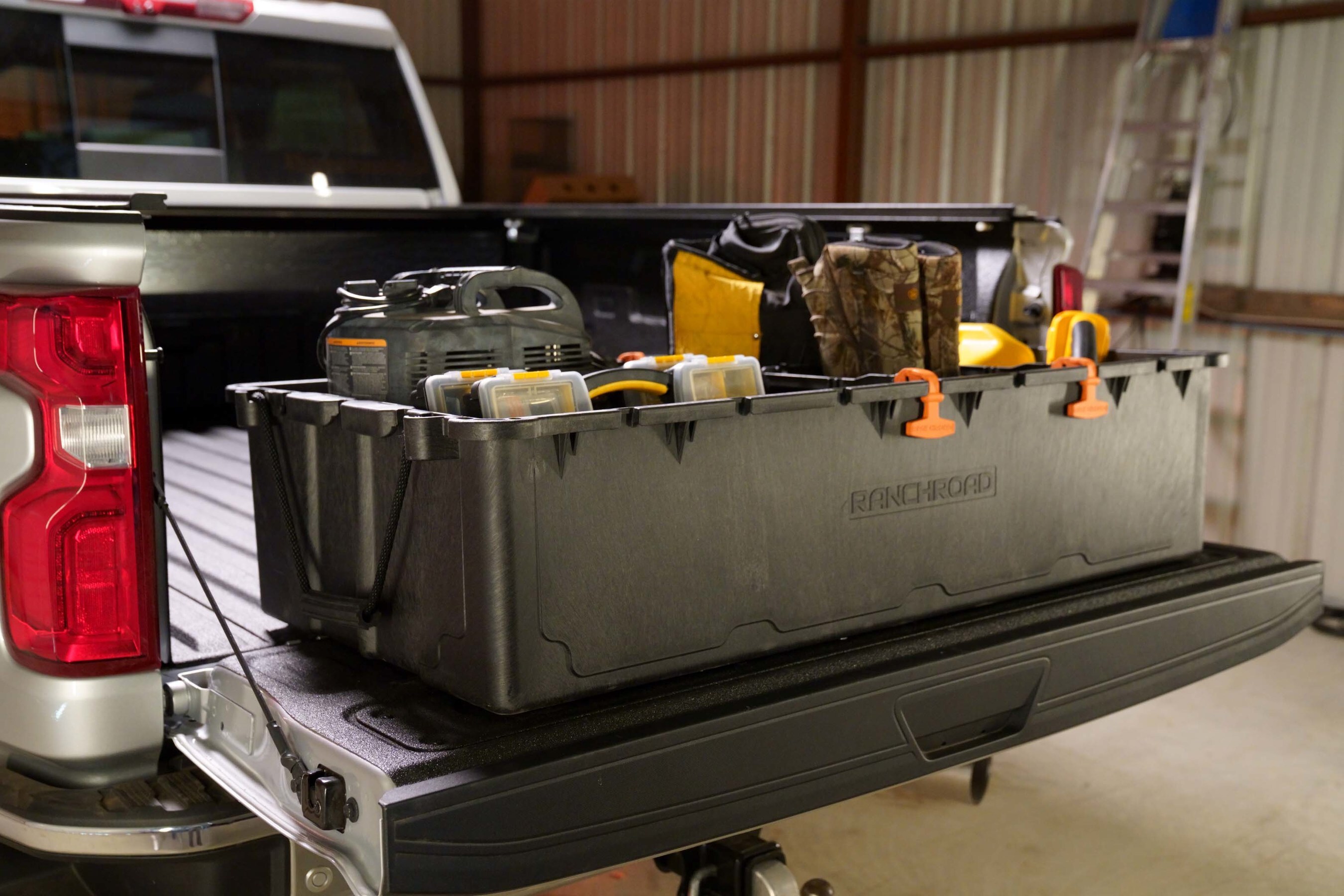 Ranch Road cargo box in a pickup truck bed, loaded with tools and gear