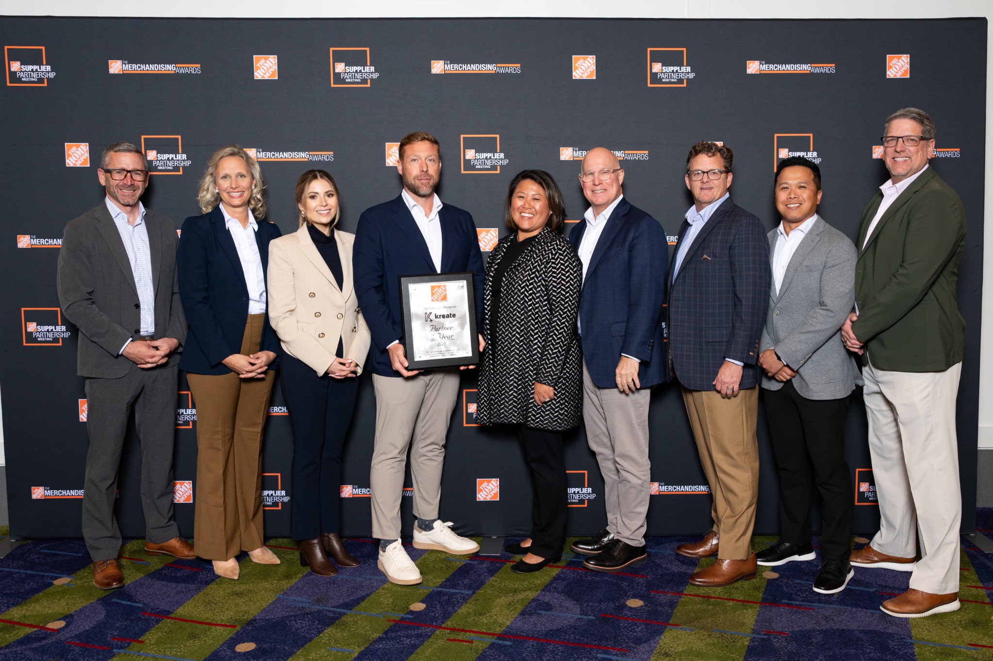 Kreate and The Home Depot team members holding the Partner of the Year award at The Home Depot supplier awards