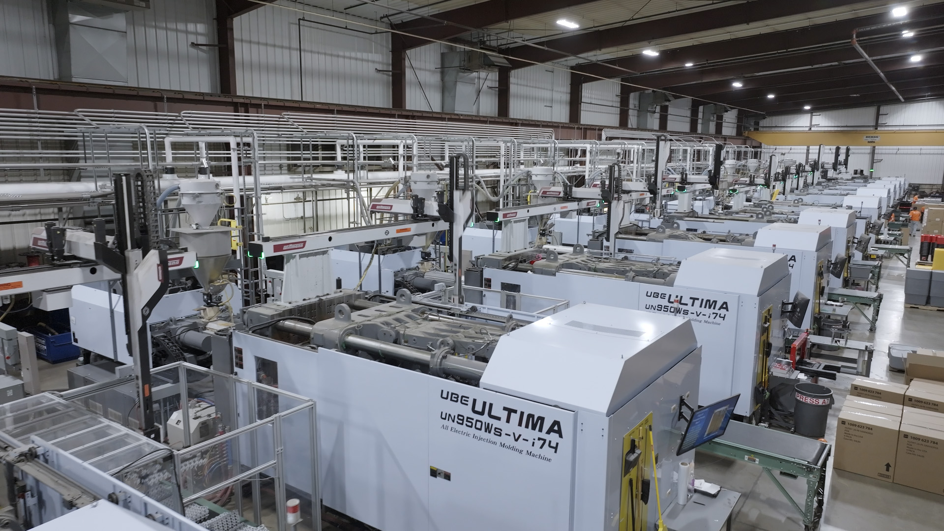 Rows of injection molding machines on a manufacturing floor