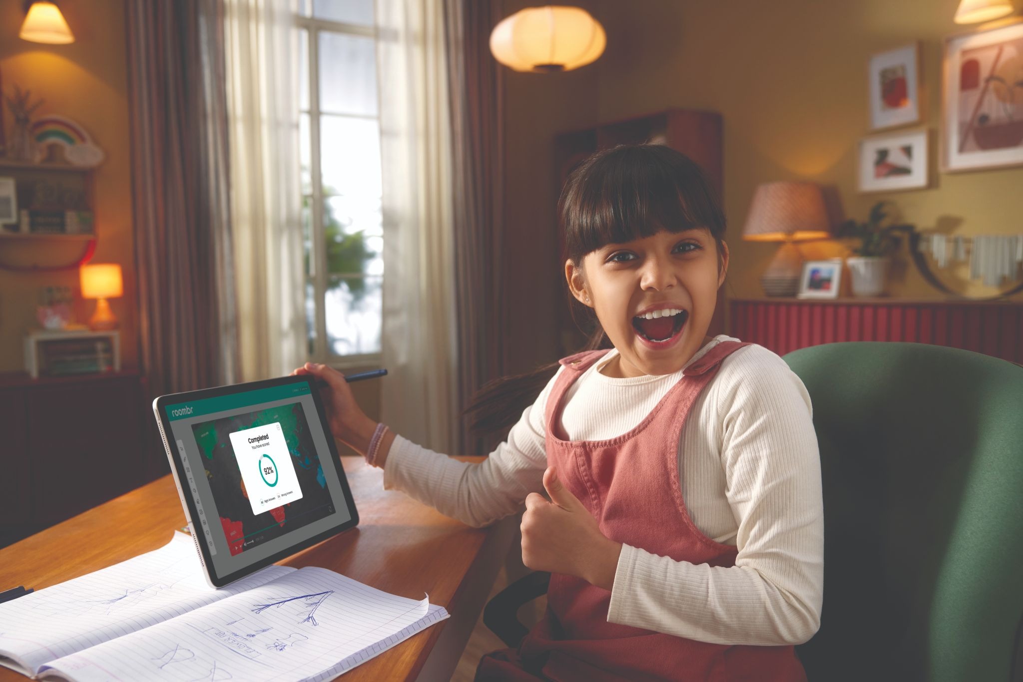 Student studying at home using Roombr digital classroom app on tablet, smiling after completing an assessment