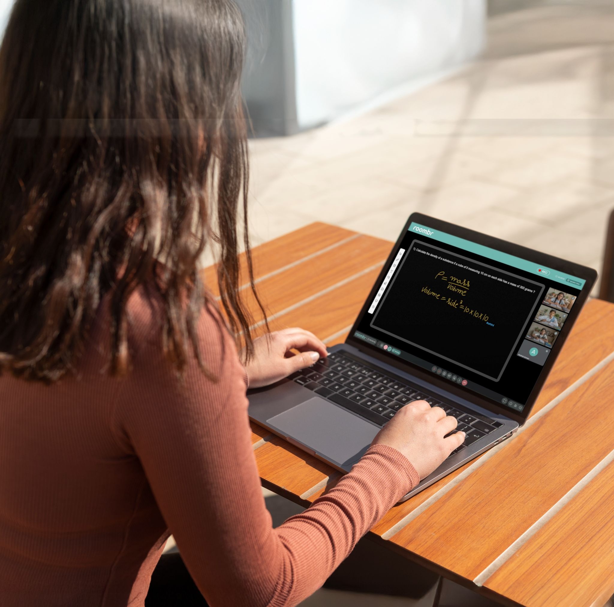 Student attending a hybrid digital class from home using a laptop.