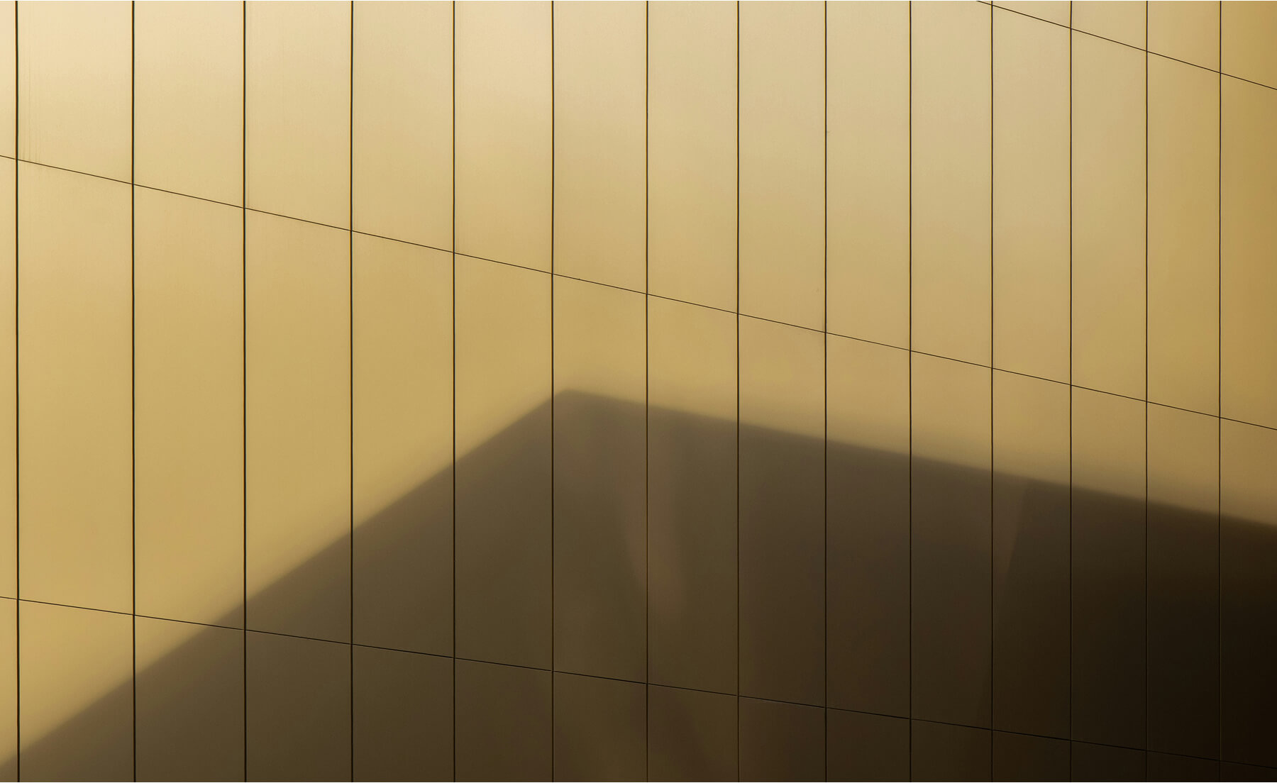 The gold exterior of a skyscraper building.