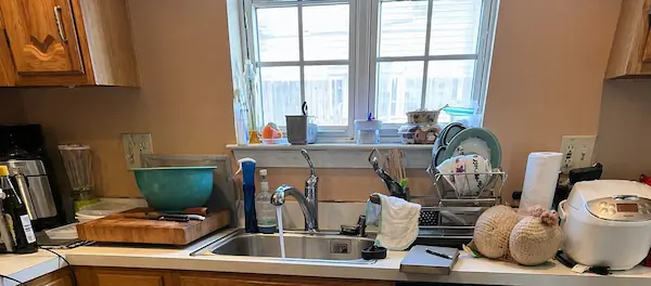 Kitchen sink with running water and faucet during plumbing inspection service in Norwalk CT