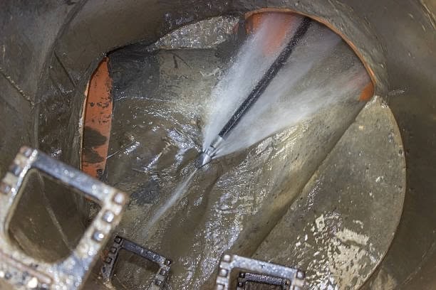 High-pressure nozzle clearing debris inside an underground pipe during professional hydro jetting in Greenwich, CT.