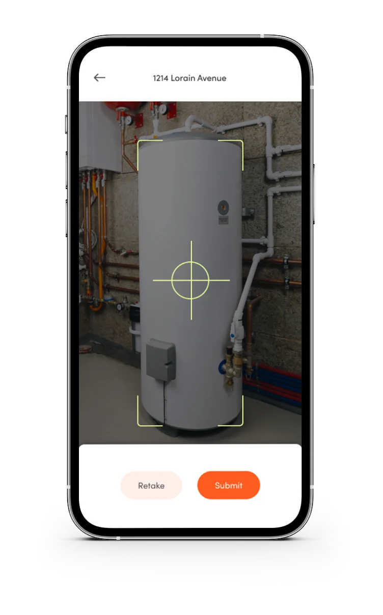 Mobile app screen showing a photo of a white cylindrical water heater with pipes in a utility room, with options to retake or submit the photo.