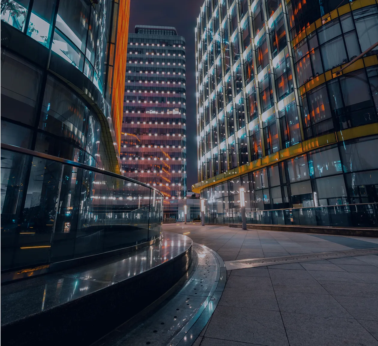 Illuminated building interior representing 24/7 financial operations