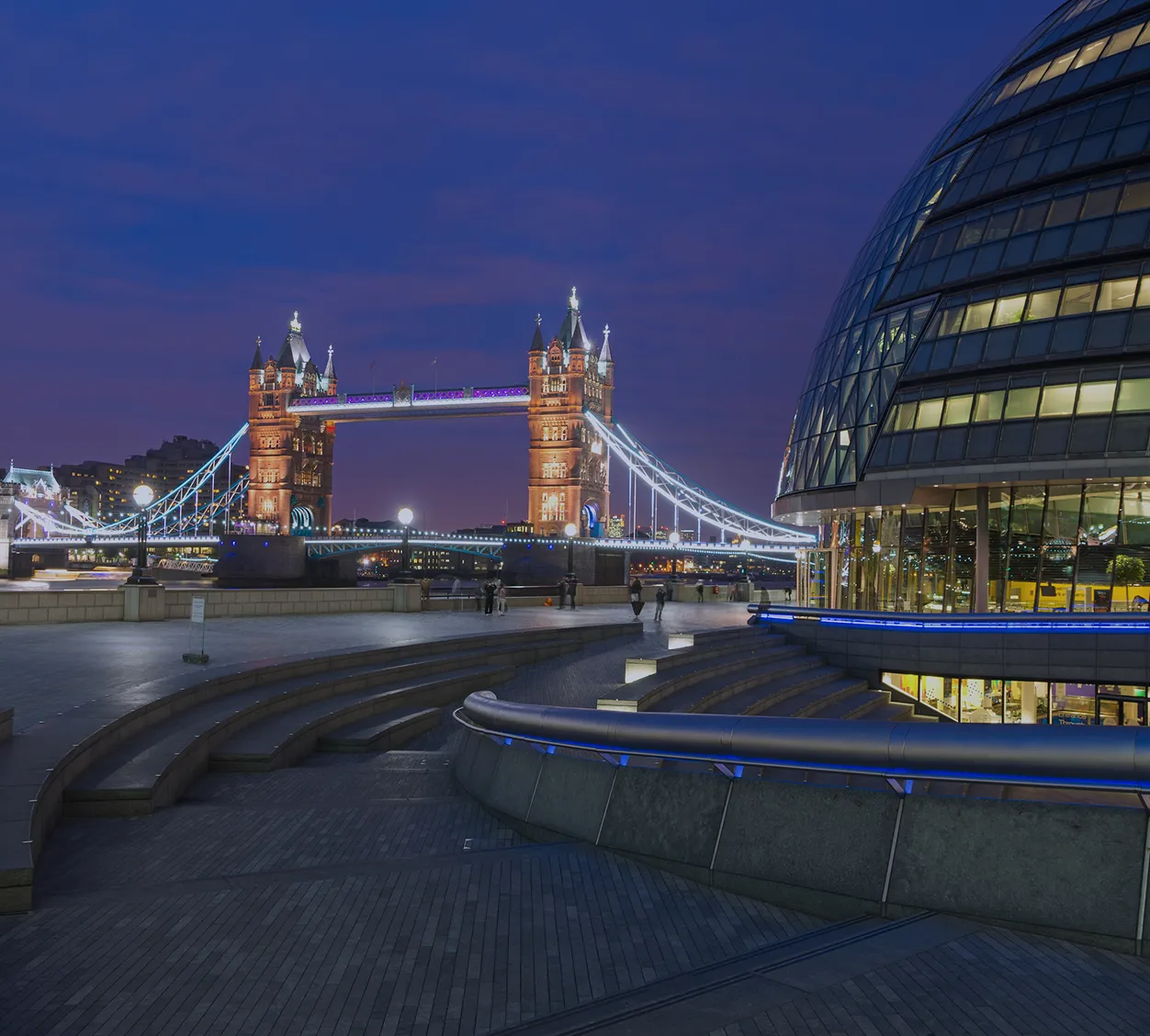 View of London’s financial district and Tower Bridge at dusk