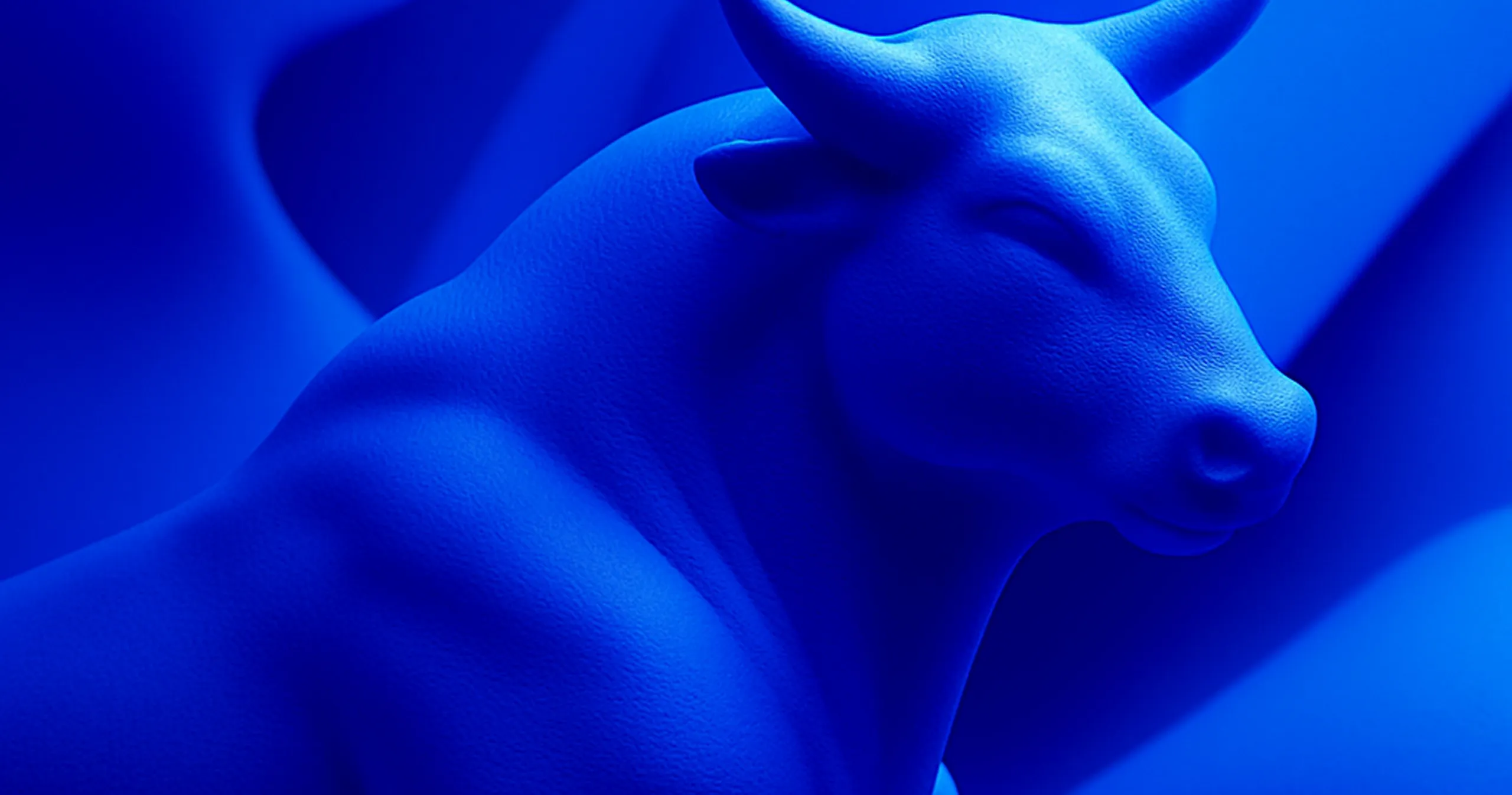 Close-up of a smooth, blue bull sculpture with visible texture and prominent horns.