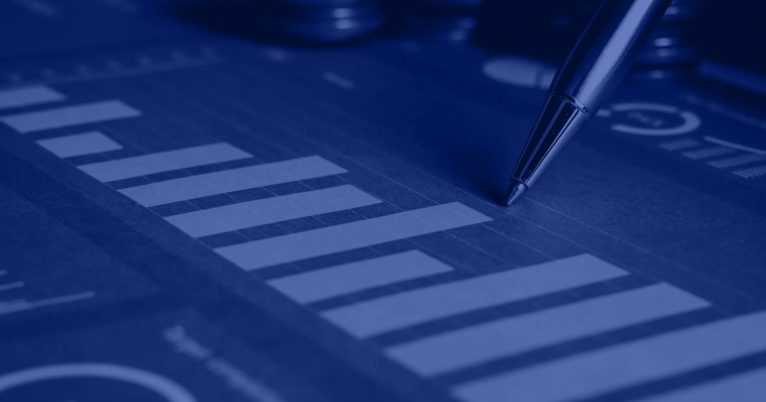 Close-up of a pen pointing at a bar chart on a financial document with a blue overlay.