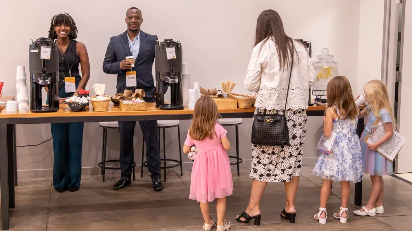 People of different ages at coffee station during professional event