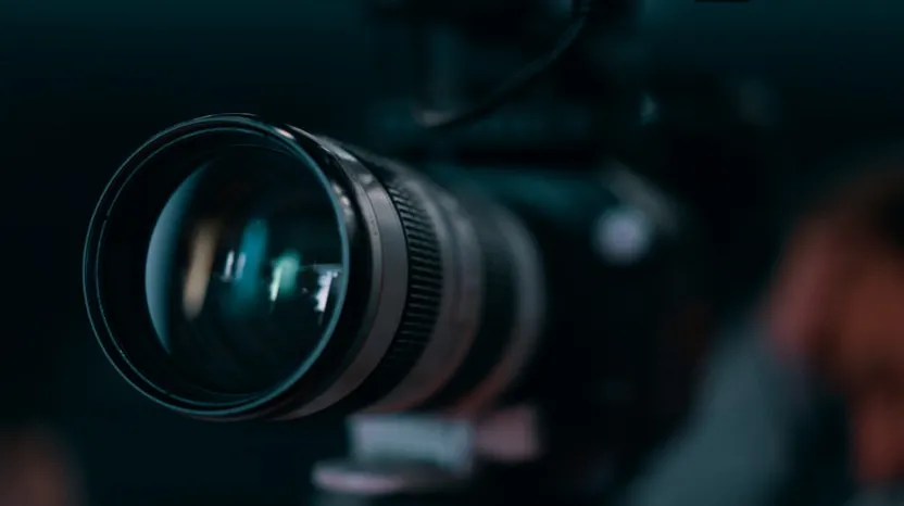 Close-up of a professional camera lens with blurred background