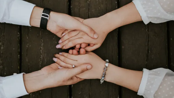 Hands clasped together, symbolizing unity, support, and connection