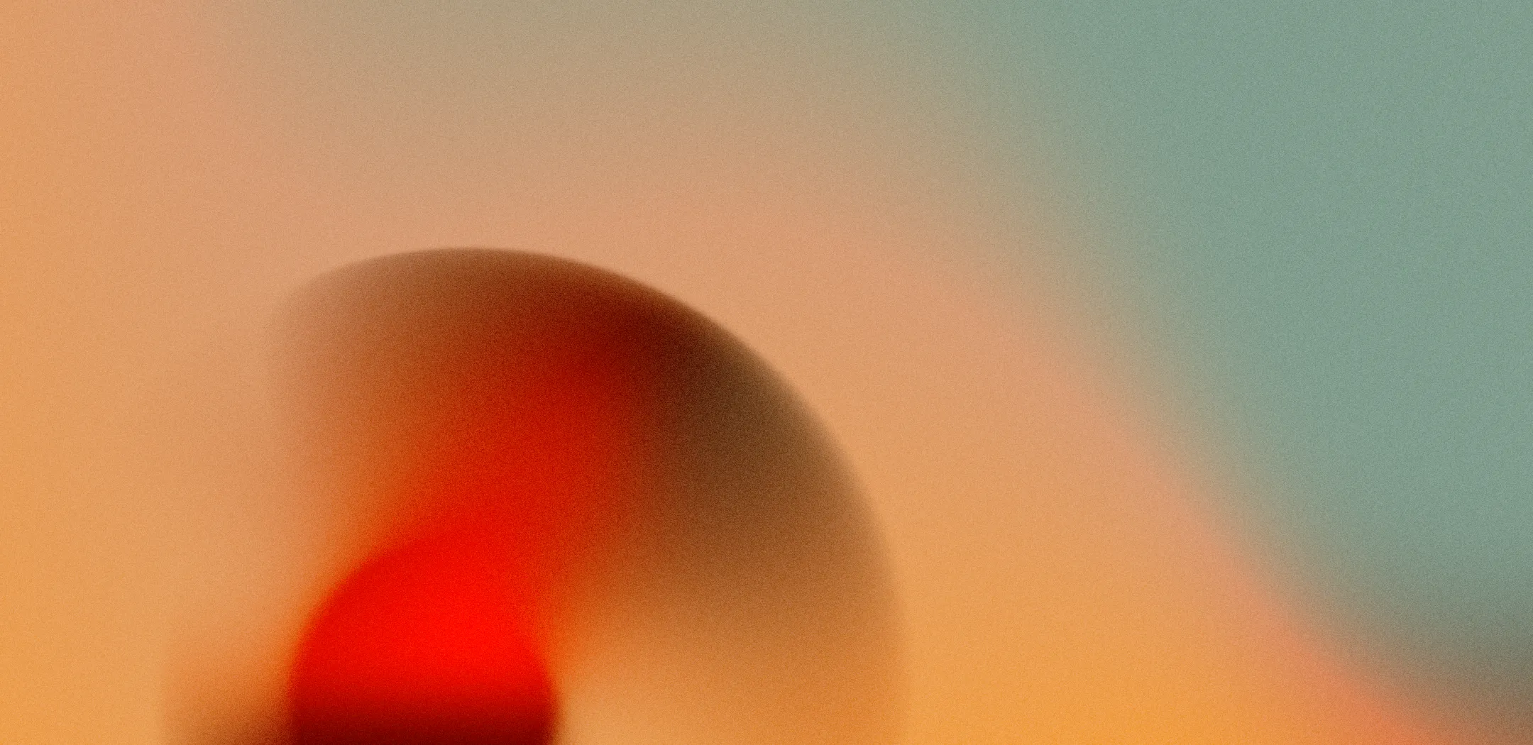 Blurry red and orange gradient with soft, curved shape
