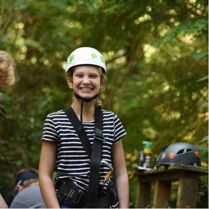 Smiling person in safety gear ready for outdoor adventure activity