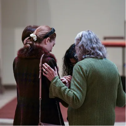 Two people embracing and comforting each other in a compassionate moment