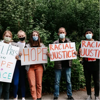 Protesters wearing masks holding signs for hope and racial justice