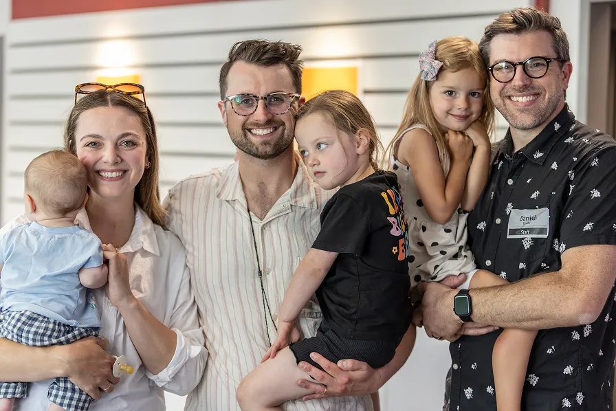Happy family with parents, children, and baby posing together indoors