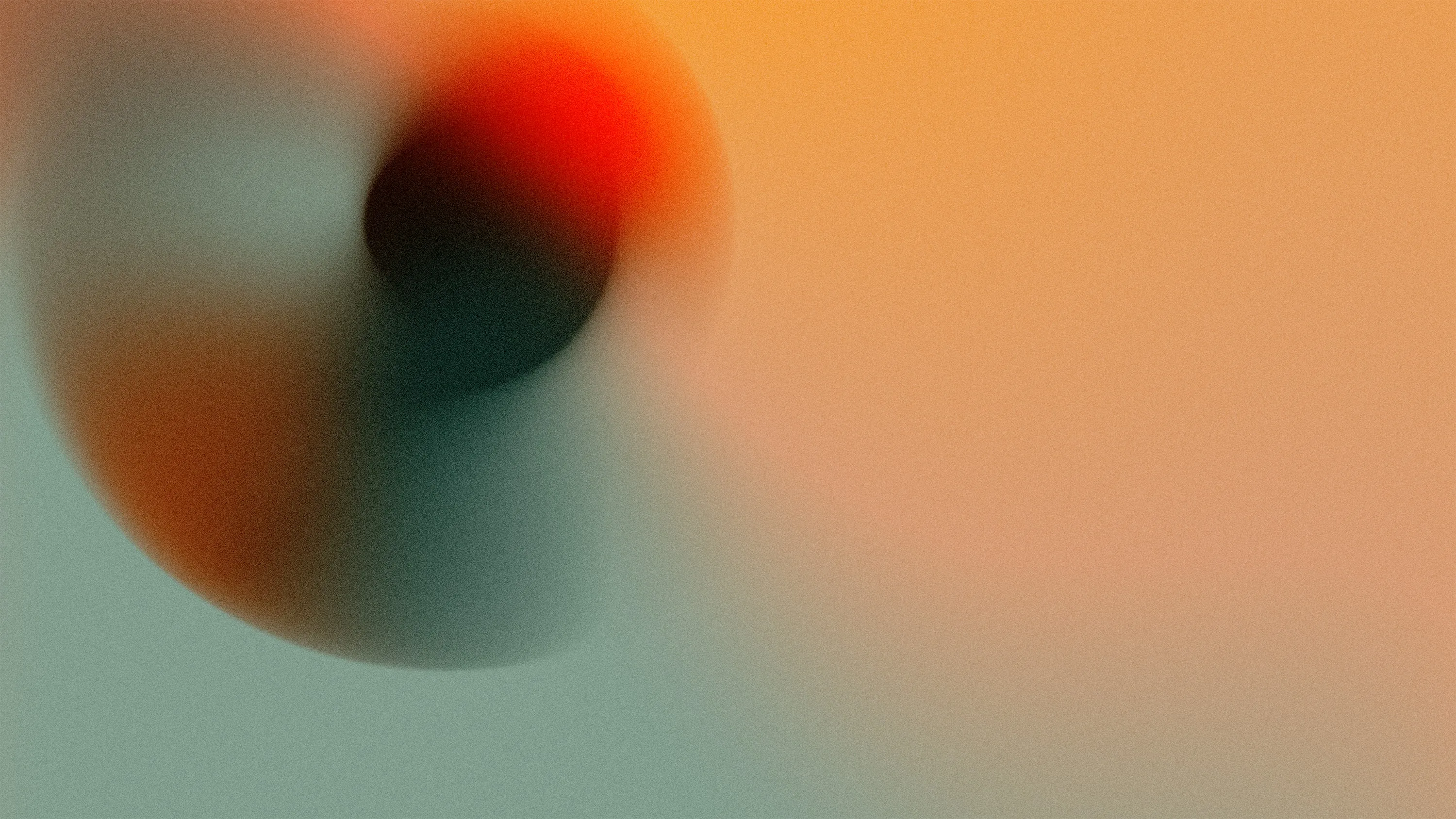 Blurred abstract image with warm orange and teal gradient colors.
