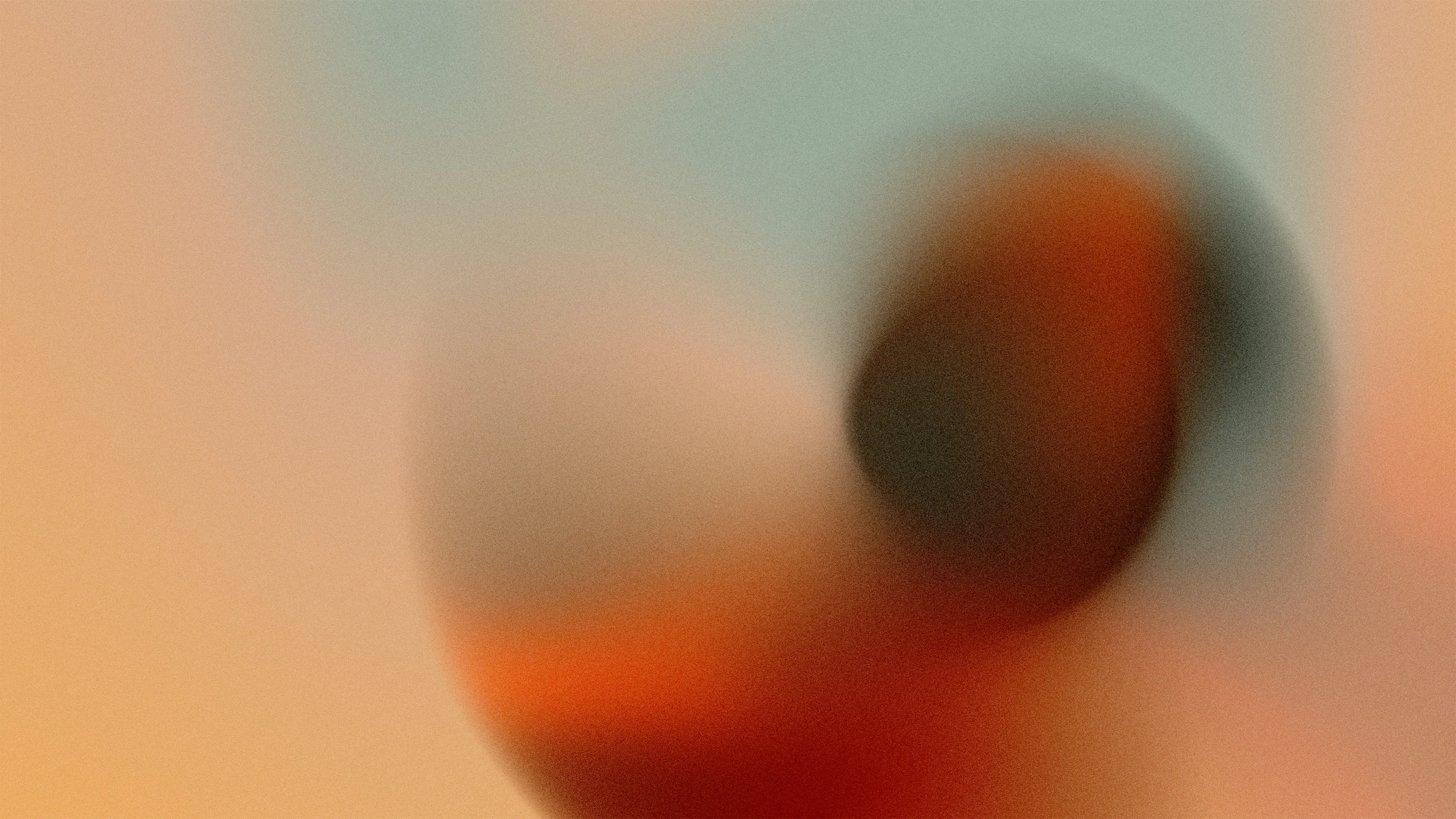 Abstract multicolor gradient with blurred, soft transitions of orange, red, gray, and beige tones.