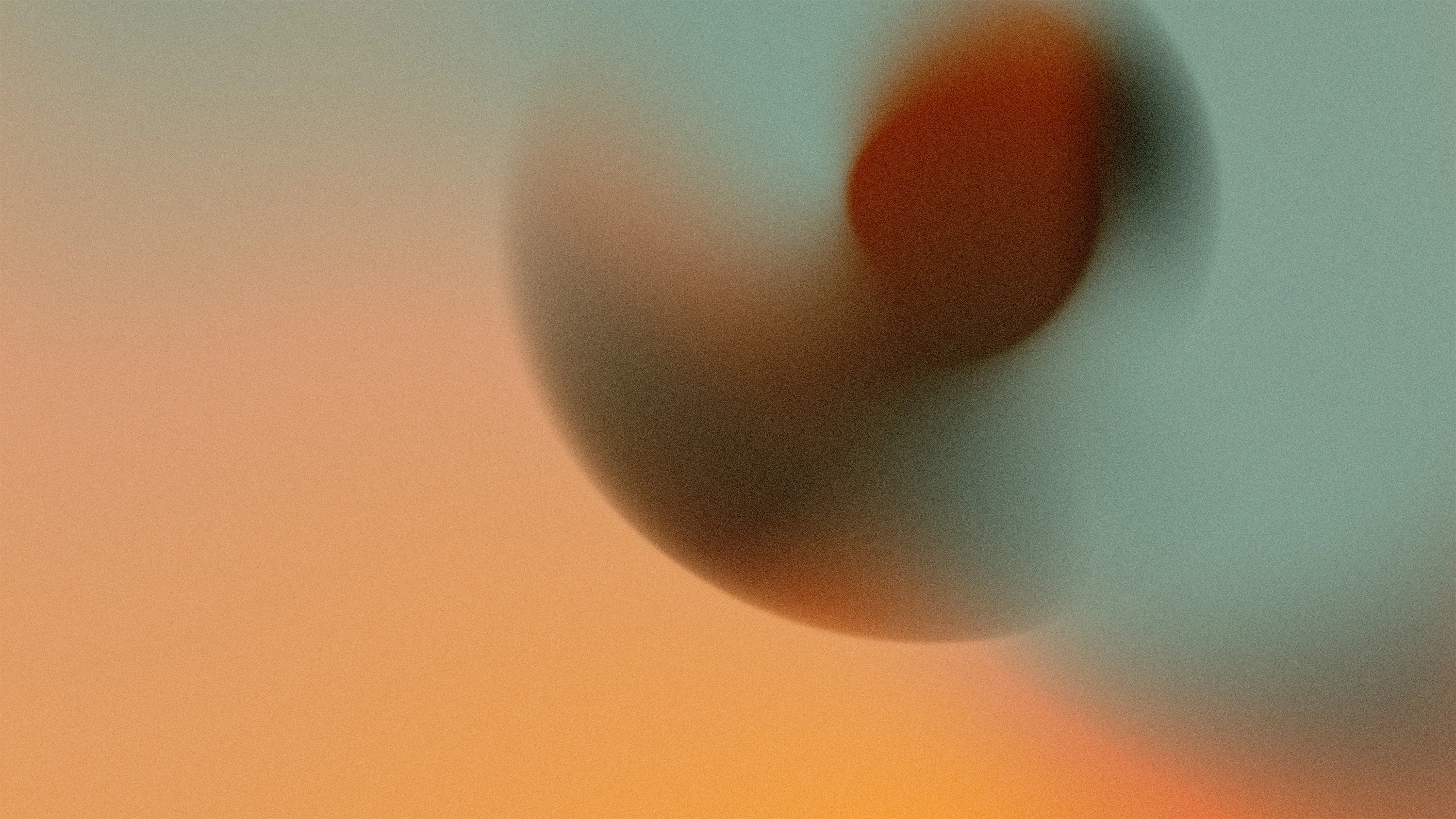 Blurred abstract shape with warm orange and cool teal tones creating a soft gradient background.
